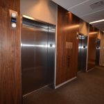 [FR] EVOLO 2  : hall d'ascenseur en noyer / [EN] EVOLO 2 : elevator lobby walnut wall panels
